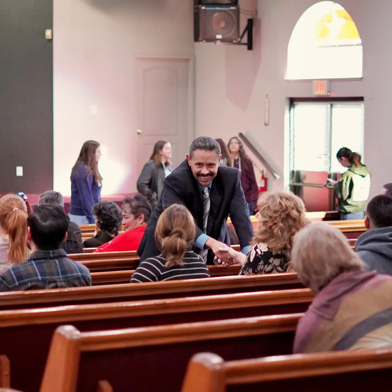 Members of the Tulare First congregation greeting one another