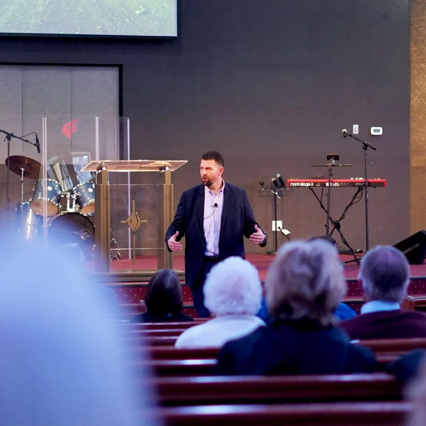 Pastor preaching from the pulpit at Tulare First